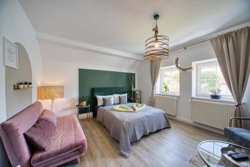 a bedroom with a bed and a couch at GreenDesign in Schkopau