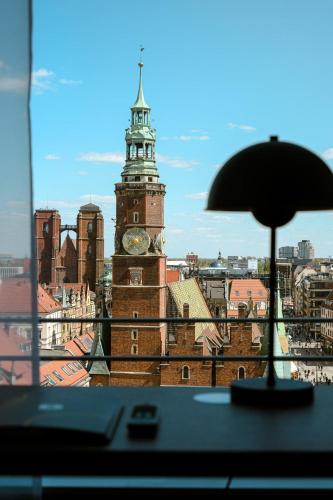 a view of a clock tower from a window at B&B HOTEL Wrocław Old Town in Wrocław