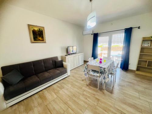 a living room with a couch and a table at Appartamenti Abbaidda in Valledoria