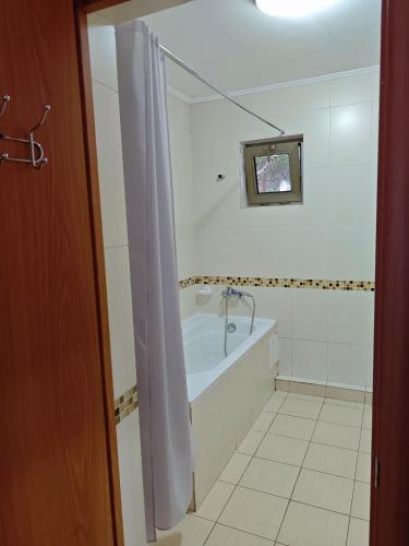 a bathroom with a bath tub and a sink at Вилла Витязь in Chok-Tal