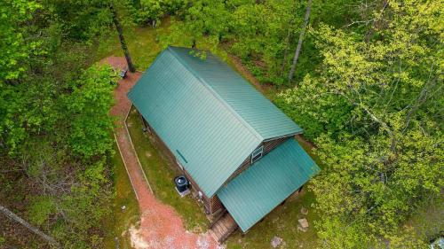 an overhead view of a blue building in a forest at Bear Hollow in Logan