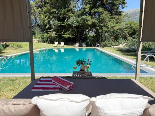 a living room with a couch and a swimming pool at Hotel Rural Xerete in Navaconcejo