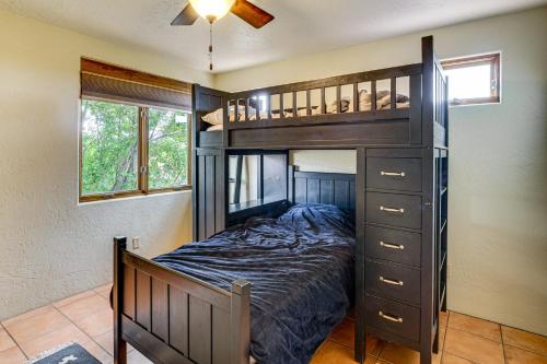 a bedroom with a bunk bed with a ladder at Adobe-Style Taos Home with Great Views! in Taos
