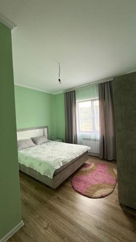 a bedroom with a bed and a window at Kolsai Terrassa in Saty