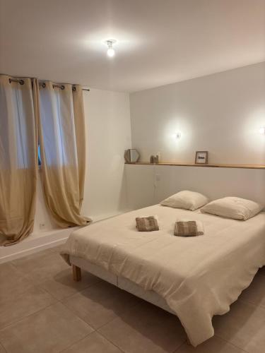 a bedroom with a large bed with two pillows on it at Appartement Bastia Cardo Village in Bastia