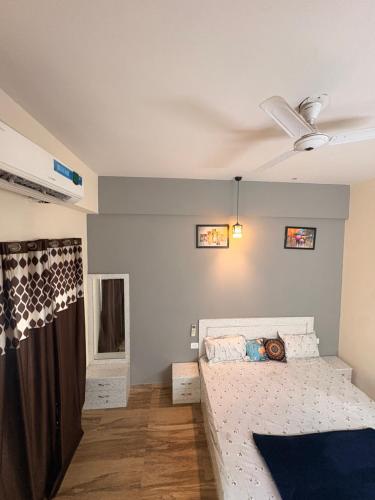 a bedroom with a bed and a ceiling at Skyline suites in Greater Noida