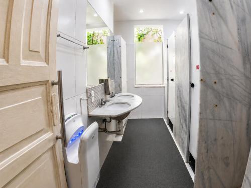 a bathroom with two sinks and a mirror at Mango Tree Ipanema in Rio de Janeiro