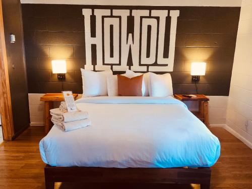 a bedroom with a large bed with a hotel sign on the wall at Elk Antler Inn in Thermopolis