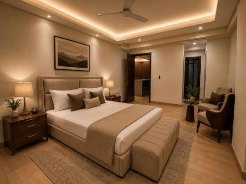 a bedroom with a large bed and a chair at LMY Boutique Prestige Hotel Apartments - Murree Monal Expressway in Murree