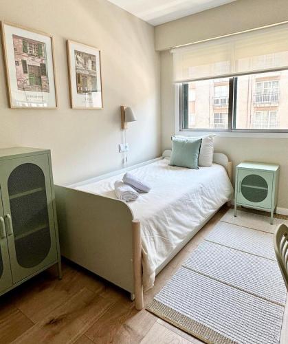 a small bedroom with a bed and a window at Alegría 2 in Amés