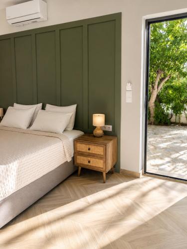 a bedroom with a bed and a table with a lamp at Maria's Studios in Frangokastello