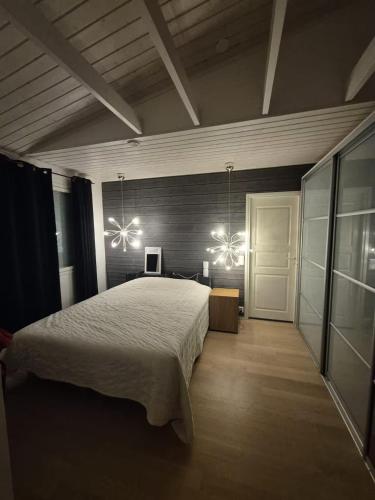 a bedroom with a large bed and two lights at Villa Herttala in Jyväskylä