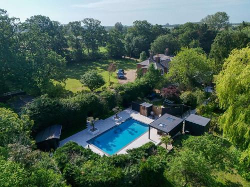 an overhead view of a swimming pool in a yard at Serenity Villa in Beccles