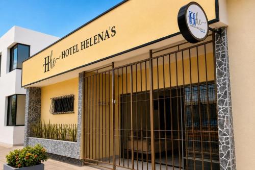 a store with a sign on the side of a building at Ayenda Hotel Helenas in Ríohacha