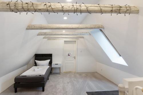 a room with a bed and a desk in a attic at Naturparadies an der Saale in Könnern