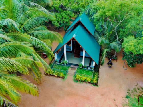 an aerial view of a house with a blue roof at Mango Tree Villa in Sigiriya