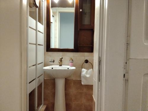 a bathroom with a white sink and a mirror at Sofia’s in Livadi