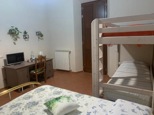 a bedroom with a bed and a desk and a bunk bed at Il Quadrifoglio Nascosto in Pontassieve