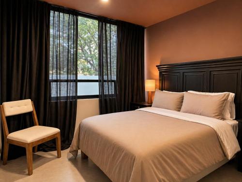 a bedroom with a large bed and a window at Casa DUALIA in San Miguel de Allende