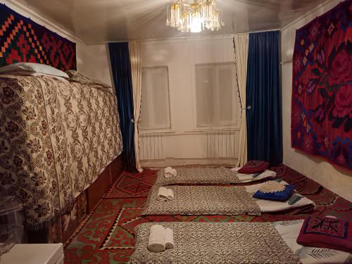 a bedroom with a bed with two mattresses on the floor at Anarhan Guesthouse Horse riding to Song-Kol and Kilemche in Kyzart