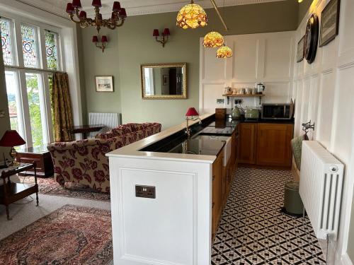a kitchen with a sink and a living room at The Vicar's View at the Old Vicarage in Lincoln