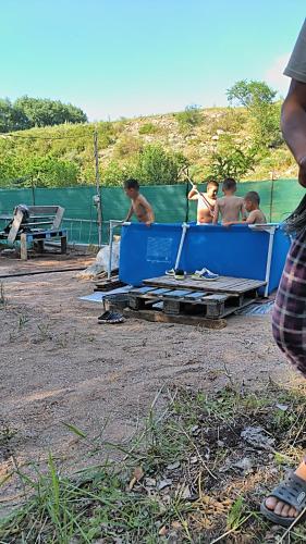 a group of men sitting in a blue container at Дача in Vorontsovskoye