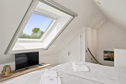 a bedroom with a large window and a bed at Amelie in Greetsiel