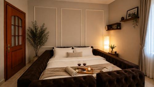 a bedroom with a large bed with a couch at Villa Nathanael in Pogradec