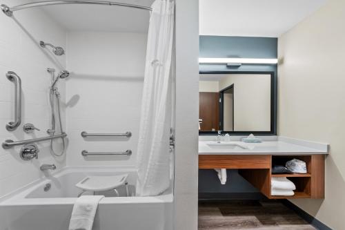 a bathroom with a shower and a tub and a sink at Everhome Suites Amarillo West - Medical Center by Choice Hotels in Amarillo
