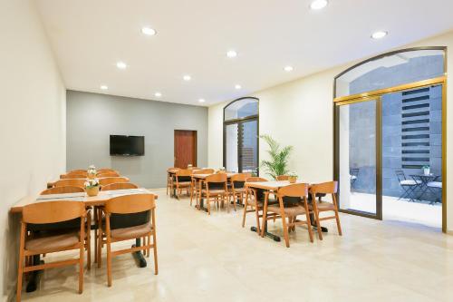 a conference room with tables and chairs and windows at Hotel Condal in Barcelona