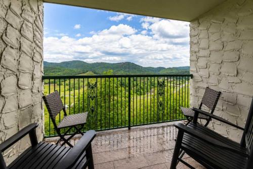 a balcony with two chairs and a view of the mountains at Mountain Views at Dolly's Castle Unit 3 in Sevierville