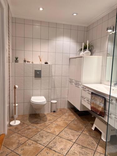 a bathroom with a toilet and a sink at Flott hus på Tasta in Stavanger