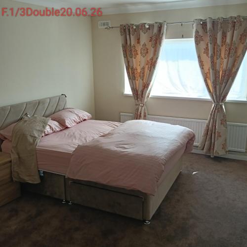 ein Schlafzimmer mit zwei Betten und einem Fenster in der Unterkunft Double bedroom with shared facilities in Lexden
