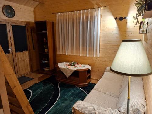 a room with a bed and a table and a lamp at Puhkemökk in Sõmera