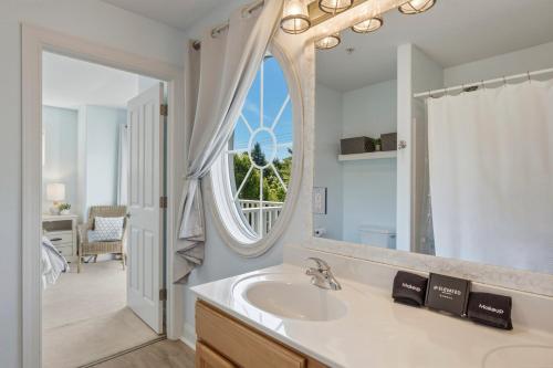 a bathroom with a sink and a large mirror at Downtown Oasis by the Bay in Traverse City