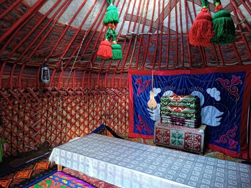 a room with a bed in a yurt at Anarhan Guesthouse Horse riding to Song-Kol and Kilemche in Kyzart
