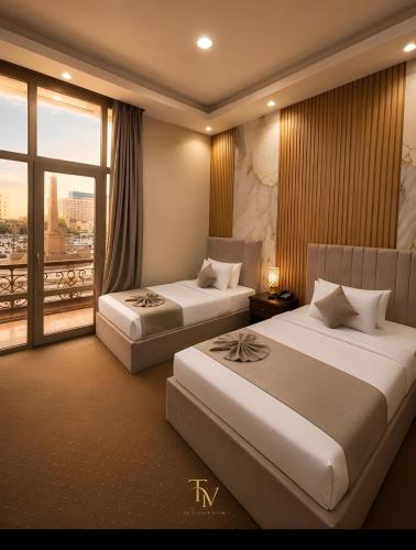 Postel nebo postele na pokoji v ubytování Tahrir Crown View Hotel - Downtown