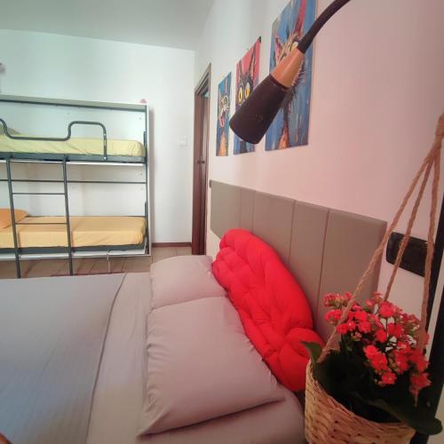 a living room with a couch with a red pillow at Leo House in Trezzo sullʼAdda