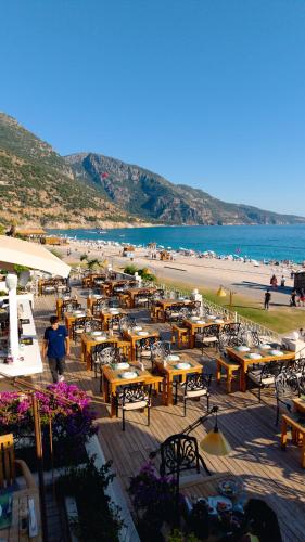 a group of tables and chairs on a beach at Jade Residence in Oludeniz