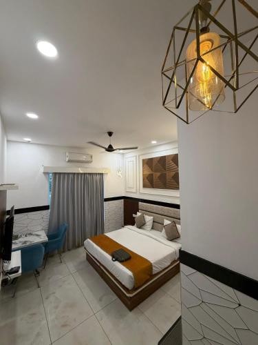 a bedroom with a bed and a desk and a lamp at Crystal Garden in Lalru