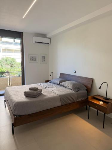 a bedroom with a large bed and a window at Notos Suites in Athens