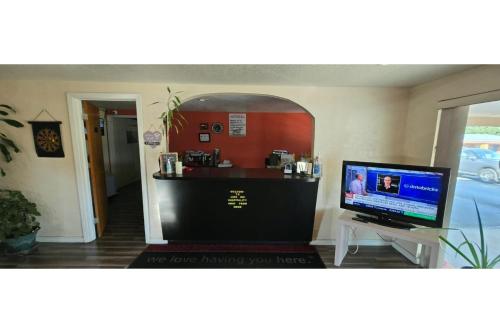 a room with a bar with a computer on a desk at Lion Inn Albemarle By Hotel O Near US 52 in Albemarle