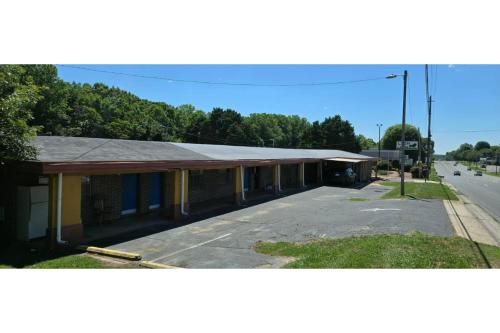 an empty building on the side of a street at Lion Inn Albemarle By Hotel O Near US 52 in Albemarle