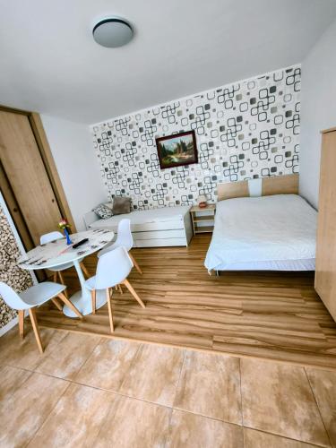 a bedroom with a bed and a table and chairs at Willa WiK in Rewal