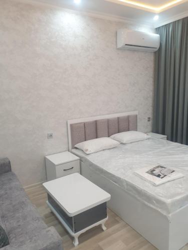 a white bedroom with a bed and a couch at Terras Astara in Astara