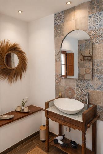 a bathroom with a sink and a mirror at Finca Altozano - Private pool in Valle de Abdalagís