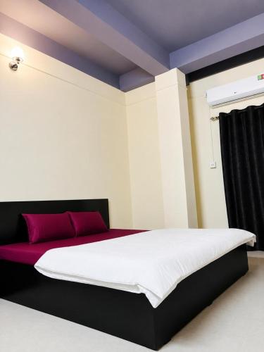 a bedroom with a large bed with a purple ceiling at Moonleaf Stay, Guwahati in Guwahati