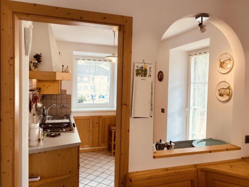 a kitchen with a sink and a counter top at My sweet home in the Dolomites - Appartamento LatteMiele in Predazzo