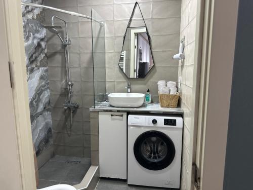 a bathroom with a washing machine and a sink at central square in Kutaisi