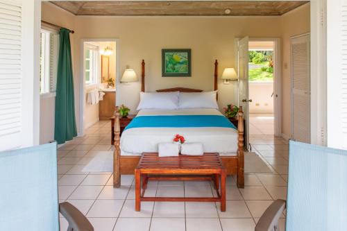 a bedroom in a villa with a bed and a table at Plantation Beach Villas in Black Rock